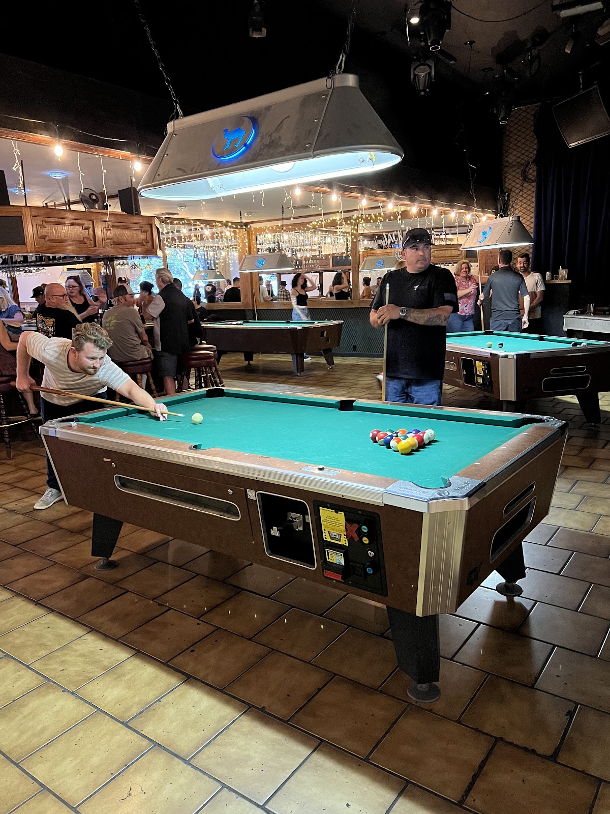 Pool tables inside Boar Cross'n with people playing