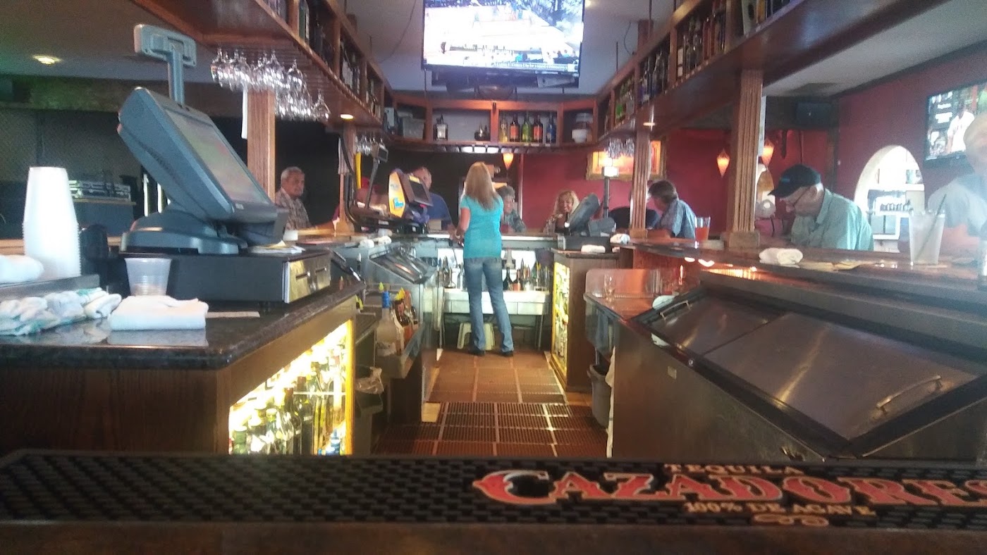 Boar Cross'n interior bar with patrons, TVs and drinks